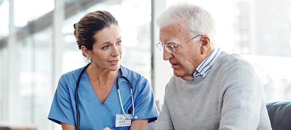 A doctor speaks to an elderly man